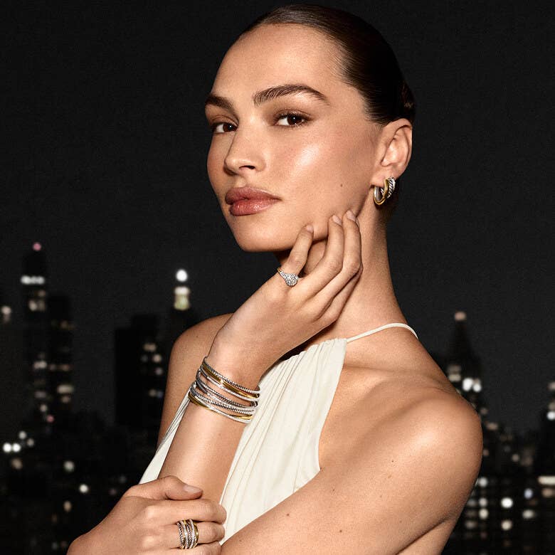 A model wearing stacked bracelets.